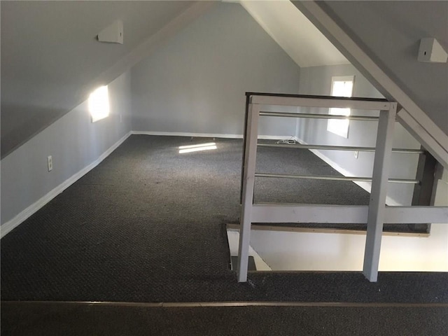 additional living space with vaulted ceiling, carpet floors, and baseboards