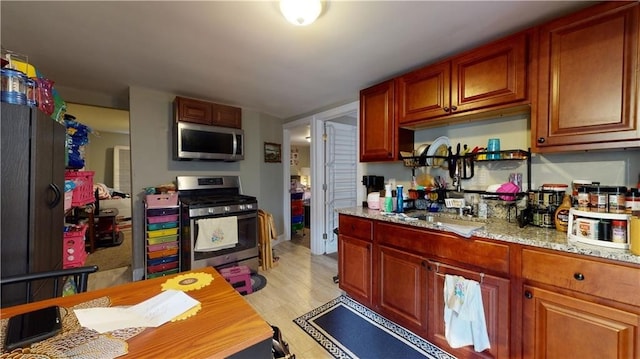 kitchen with appliances with stainless steel finishes and light stone countertops