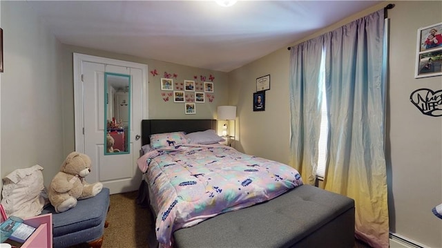 bedroom featuring a baseboard heating unit and carpet flooring