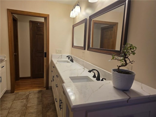 full bath featuring double vanity and a sink