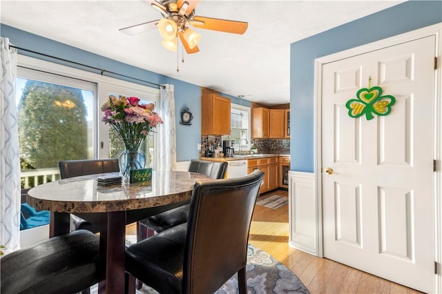 dining space featuring a ceiling fan and light wood-style floors