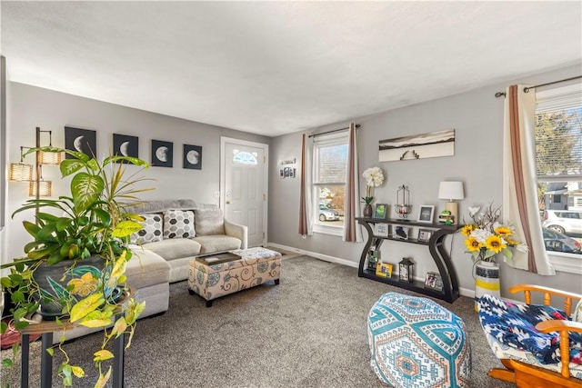 carpeted living area featuring baseboards