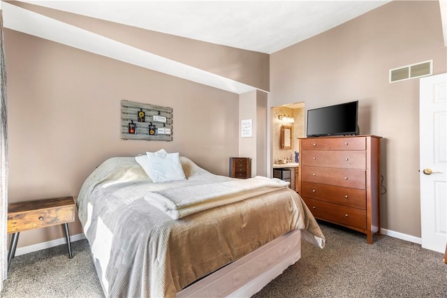 carpeted bedroom with vaulted ceiling, connected bathroom, visible vents, and baseboards