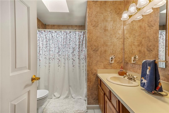 bathroom with curtained shower, tile patterned flooring, toilet, a skylight, and vanity