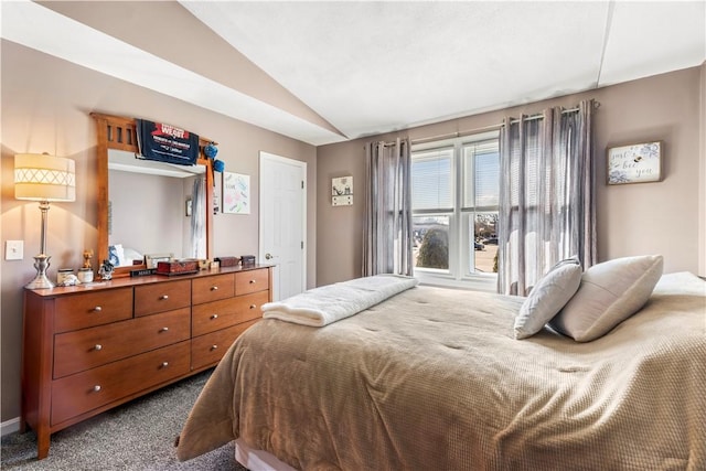 bedroom with lofted ceiling and dark carpet