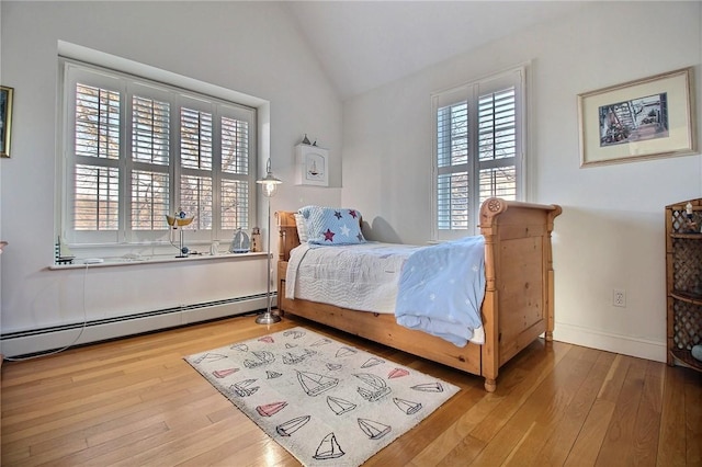 bedroom featuring lofted ceiling, baseboard heating, wood-type flooring, and baseboards