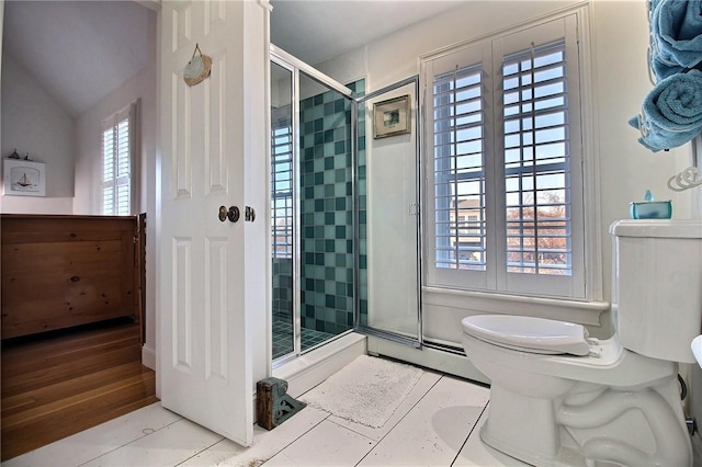 bathroom featuring a shower stall and toilet