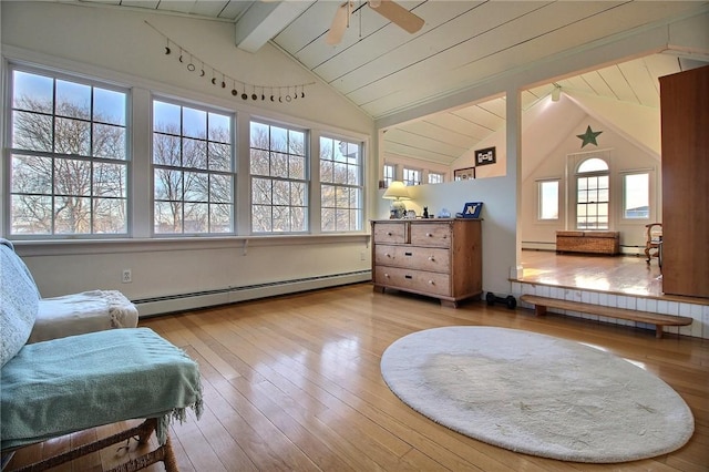 living area with a baseboard heating unit, wood-type flooring, vaulted ceiling with beams, and a ceiling fan