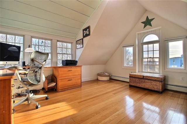 office space with lofted ceiling, baseboards, hardwood / wood-style floors, and a baseboard radiator