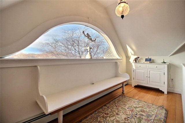 sitting room with lofted ceiling and light wood-style flooring