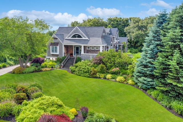 view of front of home featuring a front lawn and stairs