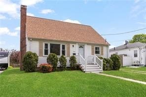 view of front of house with a chimney and a front yard