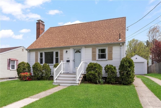 view of front of home featuring a garage, a chimney, a front lawn, and an outdoor structure