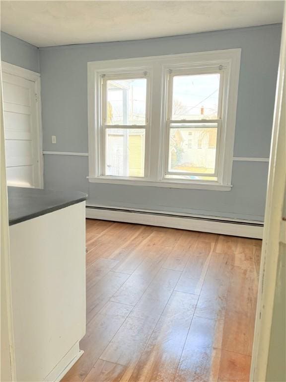 interior space with baseboard heating and hardwood / wood-style floors