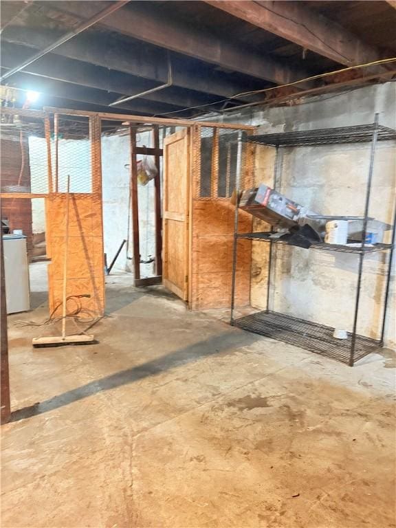 unfinished basement featuring washer / clothes dryer