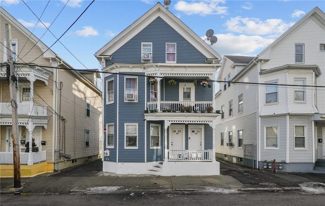 view of front of house featuring a balcony and cooling unit