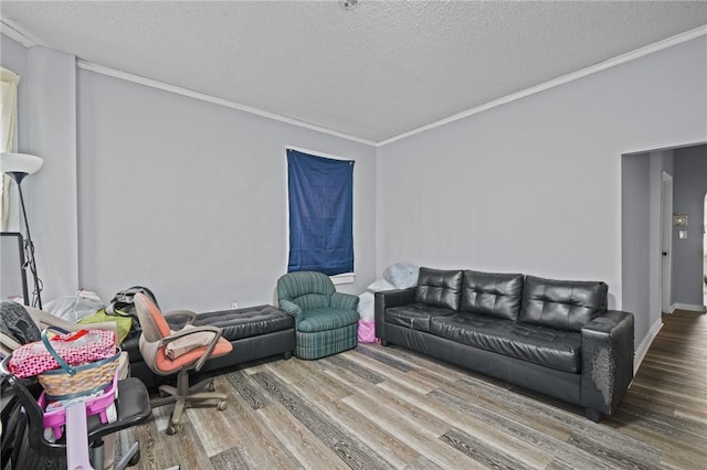 living room with a textured ceiling, wood finished floors, and crown molding