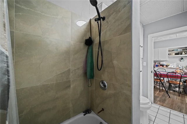 full bathroom featuring toilet and tile patterned flooring