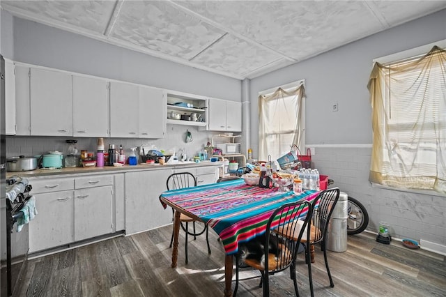 kitchen featuring dark wood-style floors, open shelves, gas stove, and white cabinets