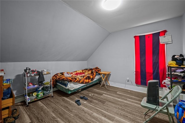 bedroom featuring vaulted ceiling and wood finished floors