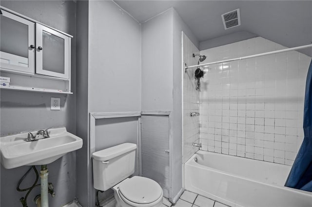 bathroom with toilet, a sink, visible vents, tile patterned floors, and shower / bath combo