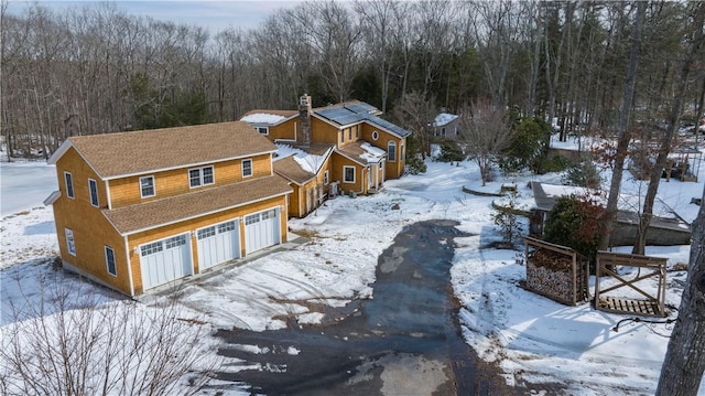 snowy aerial view with a view of trees