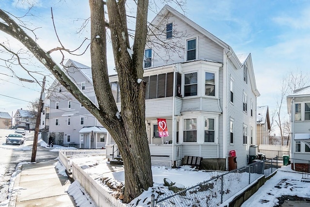 view of front facade with a residential view and fence