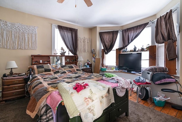 bedroom with a ceiling fan and wood finished floors