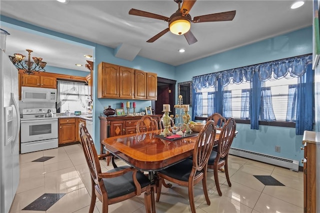 dining room featuring plenty of natural light, baseboard heating, and light tile patterned floors