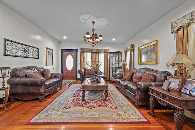 living room with a chandelier, wood finished floors, and recessed lighting