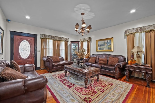 living room featuring an inviting chandelier, wood finished floors, and recessed lighting