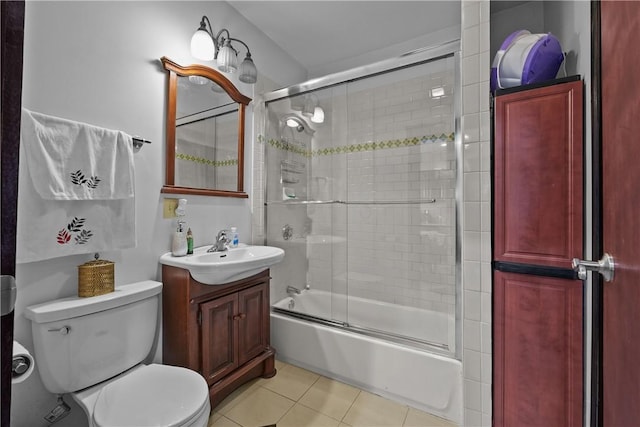 full bath featuring vanity, combined bath / shower with glass door, tile patterned flooring, and toilet