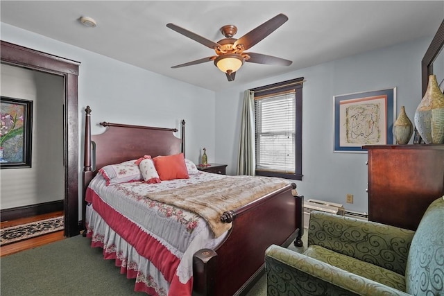 bedroom with ceiling fan and baseboards