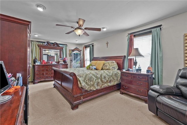 bedroom with light carpet and a ceiling fan