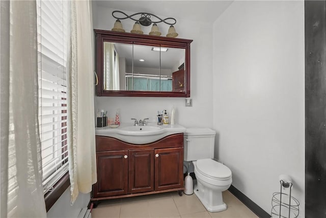 bathroom featuring baseboards, vanity, toilet, and tile patterned floors