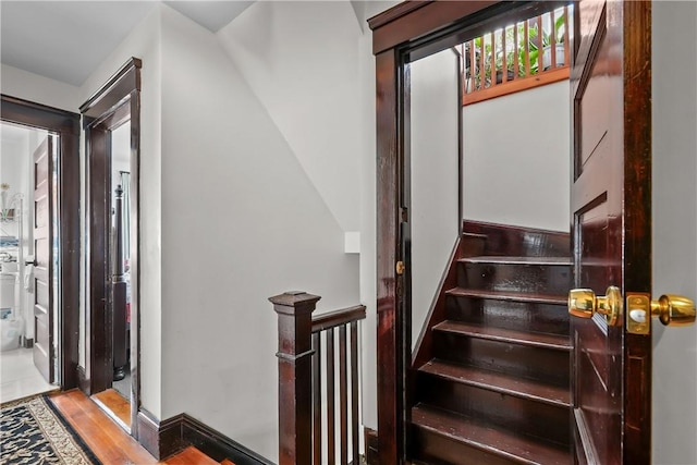 staircase with wood finished floors