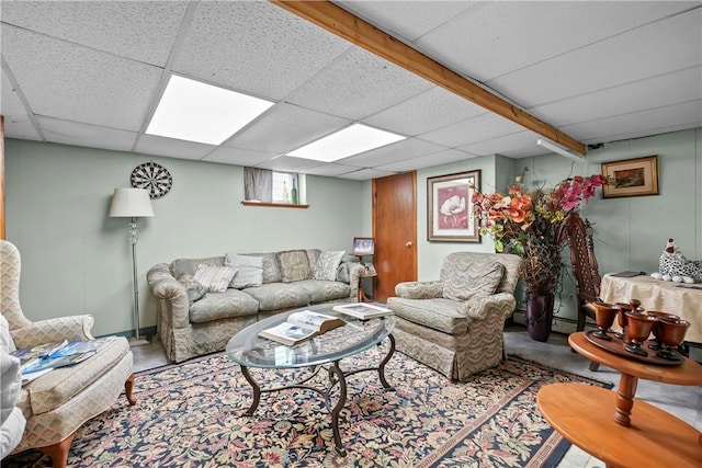 living area with a drop ceiling