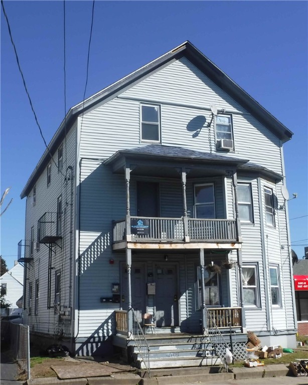 view of front of property featuring covered porch and a balcony