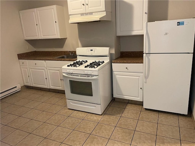 kitchen with light tile patterned floors, under cabinet range hood, white appliances, white cabinetry, and dark countertops