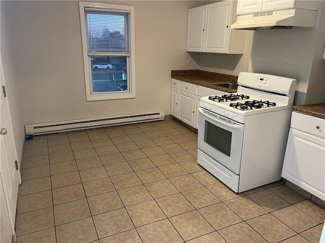 kitchen with a baseboard radiator, dark countertops, white cabinetry, under cabinet range hood, and white gas range oven