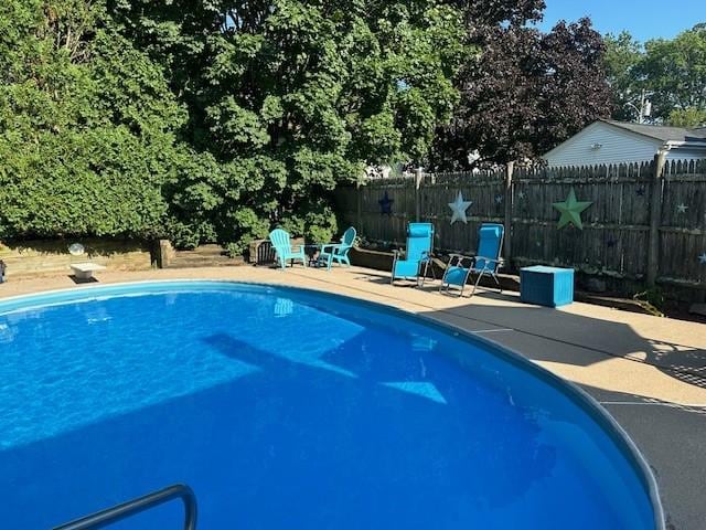 view of pool with a patio area, fence, and a fenced in pool