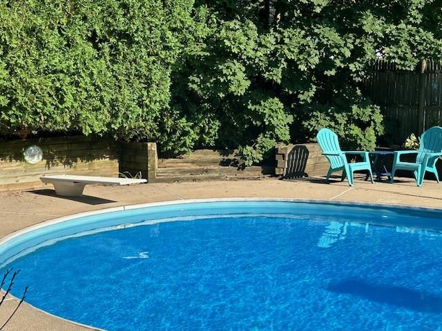 view of swimming pool with a patio, fence, and a fenced in pool