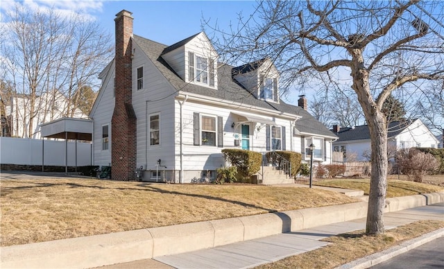 cape cod house with roof with shingles, a front lawn, a chimney, and fence