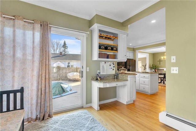 bar featuring crown molding, a baseboard radiator, black refrigerator with ice dispenser, an inviting chandelier, and light wood-style floors