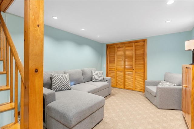 carpeted living area featuring stairs and recessed lighting