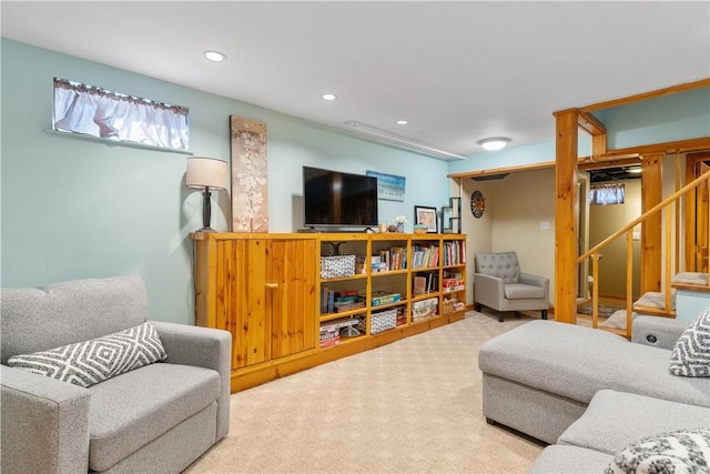 carpeted living room with recessed lighting and stairs