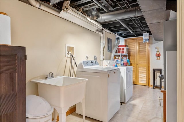 laundry room featuring laundry area, a sink, and independent washer and dryer