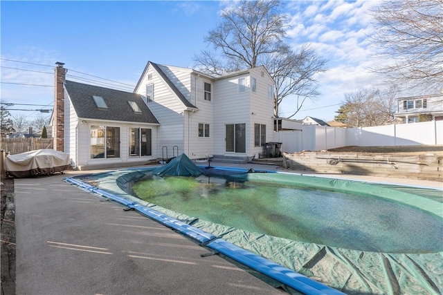 view of swimming pool with entry steps, a patio, a fenced backyard, and a fenced in pool