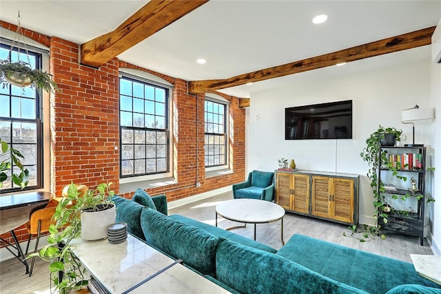 living area with recessed lighting, beam ceiling, brick wall, and wood finished floors