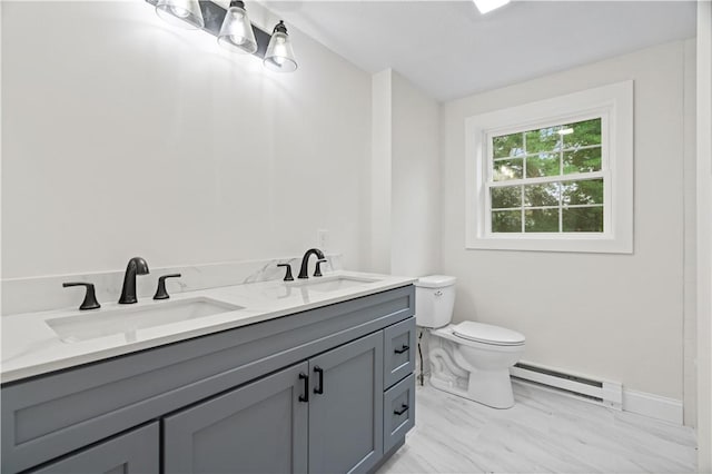 bathroom with marble finish floor, a baseboard radiator, a sink, and toilet